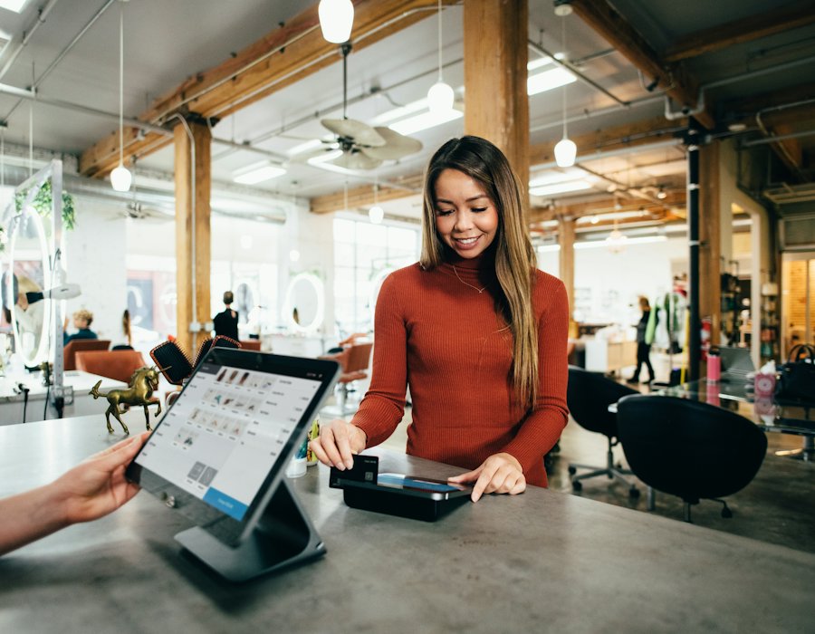 Shop owner helping a customer at the counter